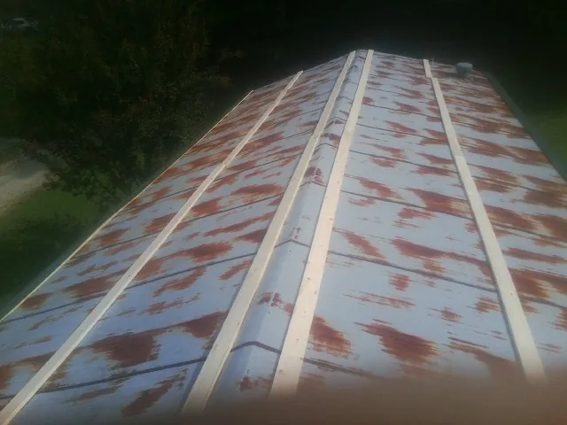 Rusted metal roof panels with new wood purlins before replacement — Storm Damage Roof Repair in Volcano by Roofing Brothers